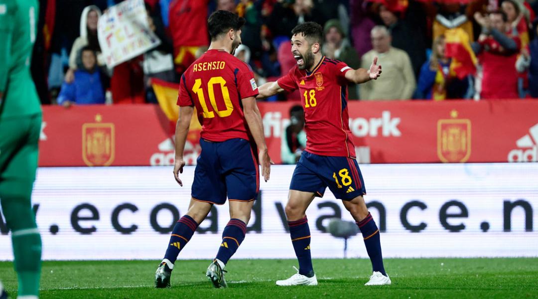 Asensio (left) and Jordi Alba (right) celebrate a goal with the Spanish national team